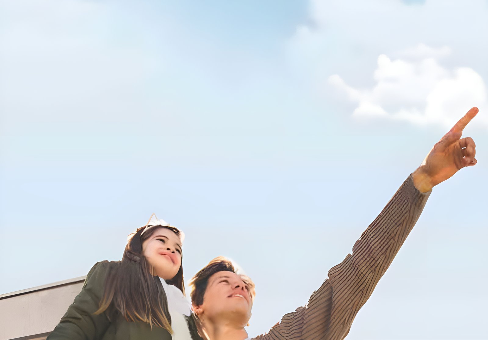 A father and daughter looking up at the open sky